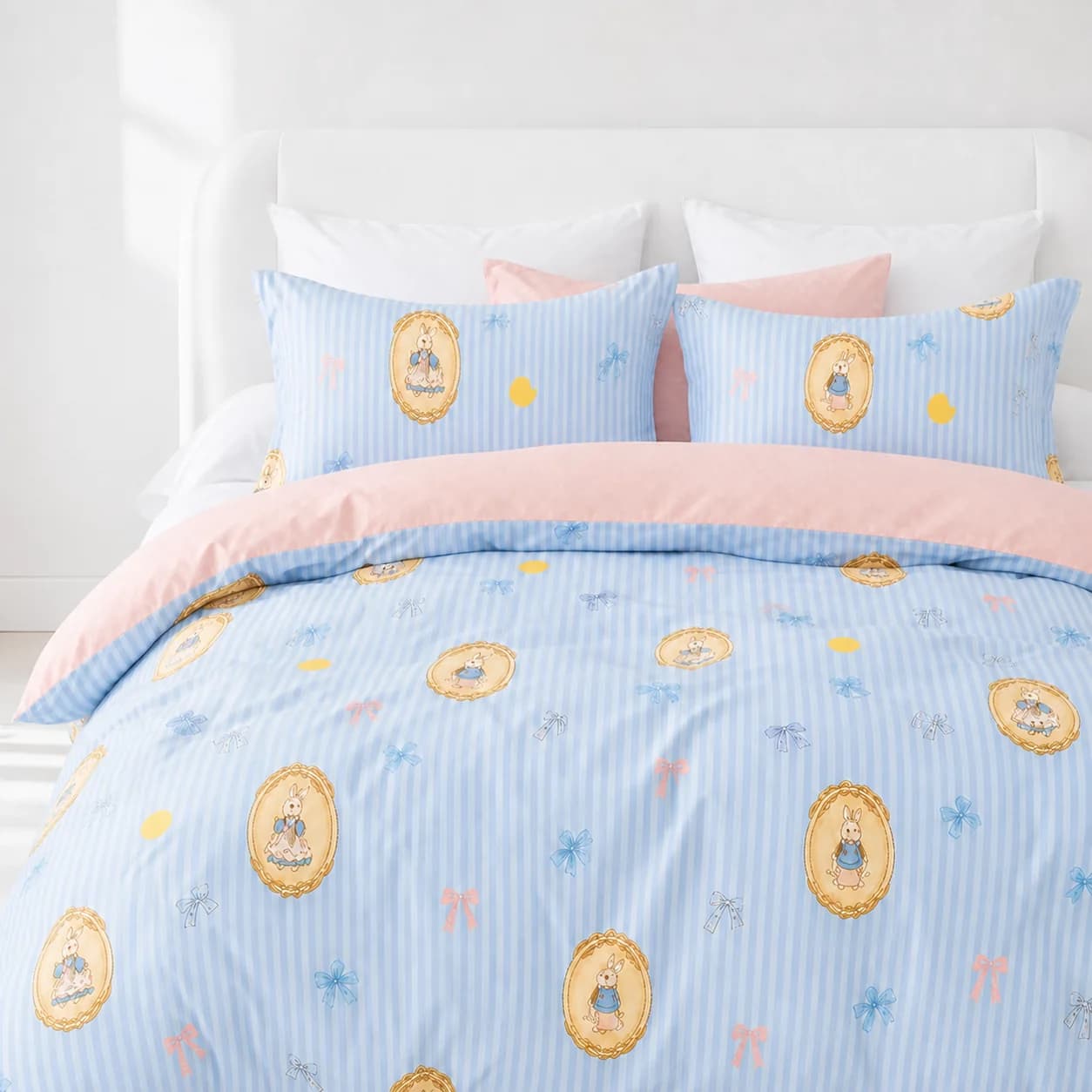 Blue and pink rabbit-print duvet cover styled on a bright white bed