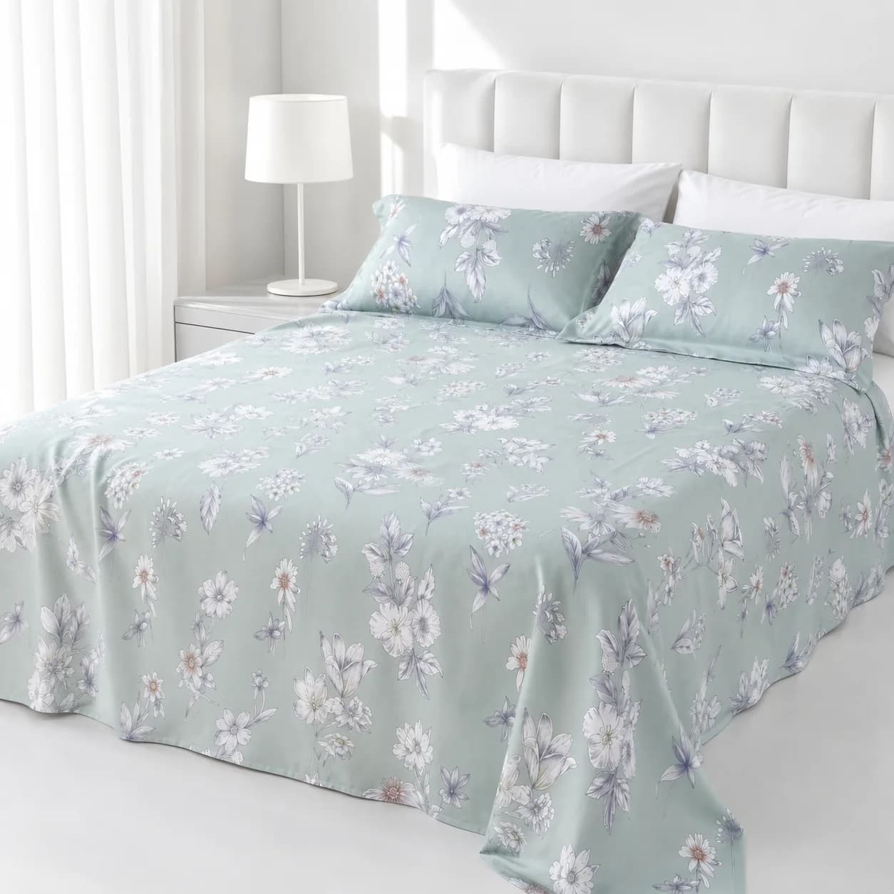 Sage floral bamboo-fiber cooling set styled on a bright white bed